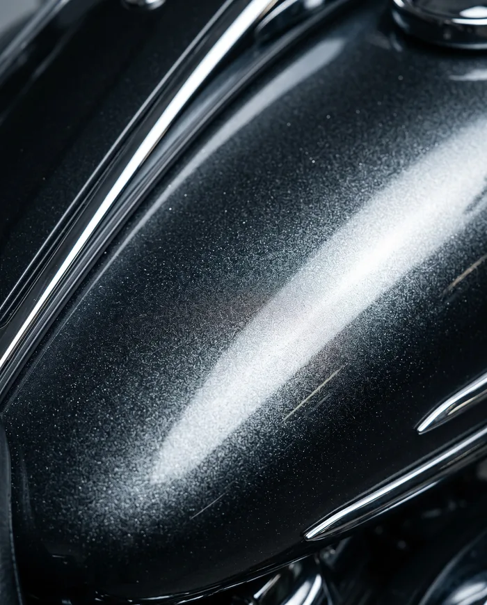 Macro of glossy metallic paint with chrome trim